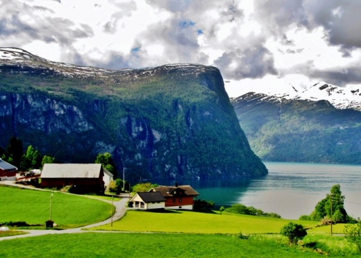 Summertime means green fields for sheep and cows and snow melt waterfalls that plunge into the deep pure waters of the fjords. 